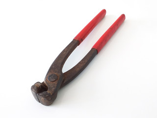 Aerial view old and rusty pliers with red handle in horizontal position isolated on white background. Close up of Old vintage rusty iron clamps.