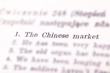 The Chinese market text highlighted, pointed out in a book, number one in a list, selective focus. China economy on the first place, printed priority list, economical issues concept