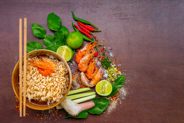 Grilled shrimp and seafood sauce is very tasty on a white plate on a wooden background,,Tom Yam...