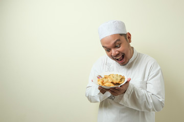 Fat Asian Moslem men feel very hungry and want to immediately devour food