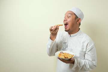 Fat Asian Moslem men feel very hungry and want to immediately devour food