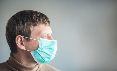 a man in medical mask indoors