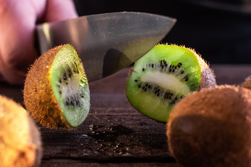 cook cuts kiwi in half