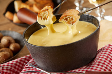 Traditional Swiss cheese fondue in cast iron pot