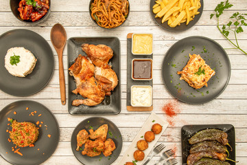 Still life with plates of grilled food