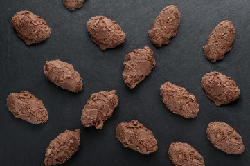 Fototapeta na wymiar a few chocolates truffle on a black stone board top shot