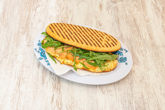 Salmon pannini on wooden table