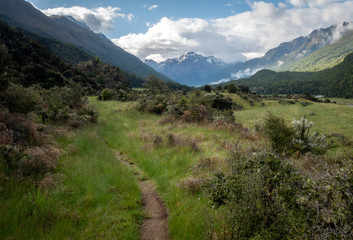 Picturesque alpine valley with dominant mountain on its end, shot on Caples Track, New Zealand