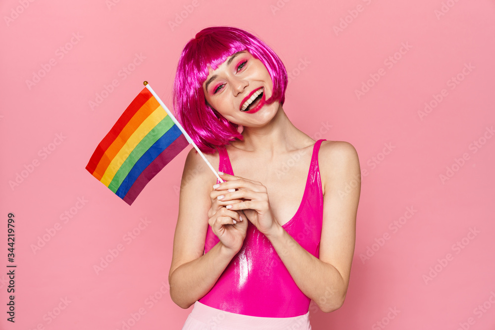 Poster image of cheerful young woman laughing and posing with rainbow flag