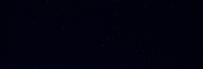 Panorama blue night sky milky way and star on dark background.Universe filled with stars, nebula and galaxy with noise and grain.Photo by long exposure and select white balance.Dark night sky.