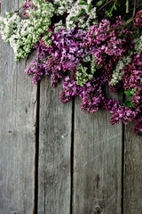 Fototapeta na wymiar Lilac flowers on a wooden background. Free space