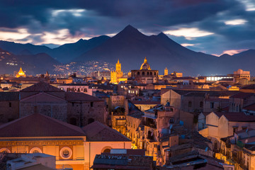 Aerial view of Palermo cathedral, mountains and rooftops of Old Town at night, Sicily, Italy