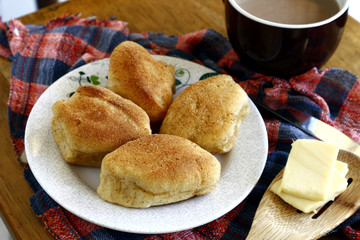 Freshly baked Filipino bread called Pan de sal or Bread of Salt, coffee, slices of cheese on a table