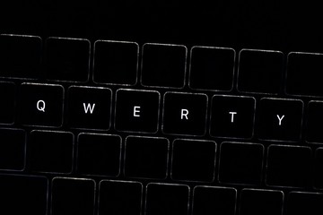 Obraz premium QWERTY. Night computer keyboard close up, keyboard light, dark theme bad password for your account 