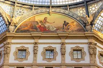 Obraz premium The interior of the Galleria Vittorio Emanuele II - Mall housed in a glass-covered 19th-century arcade with luxury clothing brands and upscale dining in Milan city, Italy