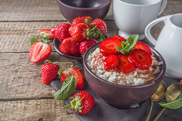 Summer morning rice pudding or rice porridge with strawberry and berry syrup in small bowl for, With milk and fresh strawberry copy space