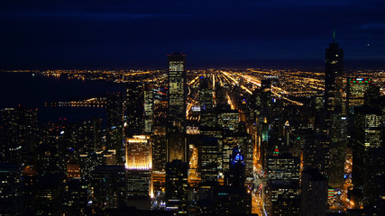 Fototapeta na wymiar CHICAGO, ILLINOIS, UNITED STATES - DEC 11th, 2015: Aerial view of Chicago downtown at night from John Hancock skyscraper high above