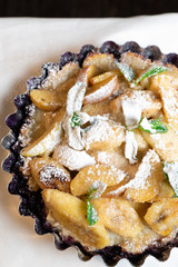 Juicy banana pie. Delicious Thanksgiving apple pie with mint or basil. Baking in the oven. Pie with banana. Sweet cupcake with baked fruit sprinkled with powder.