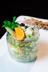 Fototapeta premium Fresh oatmeal and rice porridge with a beautiful serving and fruit. Bananas, berries, oranges and kiwi. Healthy and nutritious breakfast for children and adults. Different cereals