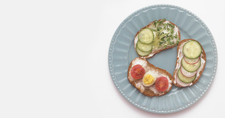 Sandwiches with vegetables, eggs, avokado and micro greens on stone background. Healthy food.