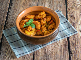King Prawn Masala in a clay bowl. Traditional Indian cuisine