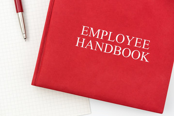 Employee Handbook or manual with a pen and paper on a white table in an office - personnel management policy, explains business goals, results, defines personnel practices - obrazy, fototapety, plakaty