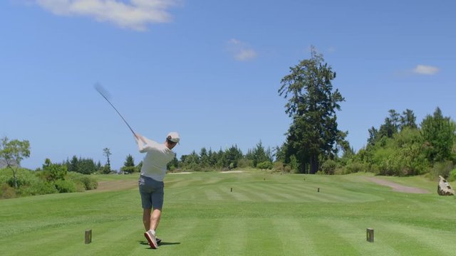 Golf man hitting driver off tee box at course