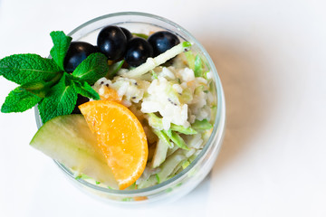 Fresh oatmeal and rice porridge with a beautiful serving and fruit. Bananas, berries, oranges and kiwi. Healthy and nutritious breakfast for children and adults. Different cereals