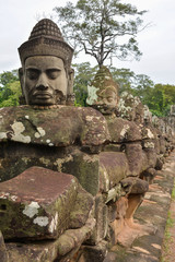 Bayon Temple in the ancient city of Angkor Thom. Statues of devas (Buddhist demigods) flanking the entrance over Siem Reap River. Cambodia