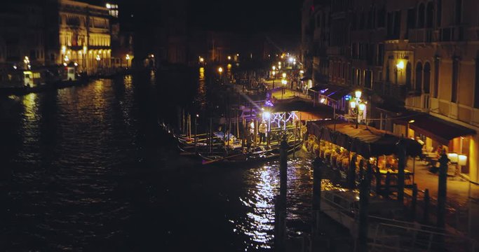 Gandoliers talk. Gandol pier on the Grand Canal, Venice, Italy. Grand Canal at night