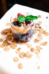 Fresh oatmeal and rice porridge with a beautiful serving and fruit. Bananas, berries, oranges and kiwi. Healthy and nutritious breakfast for children and adults. Different cereals