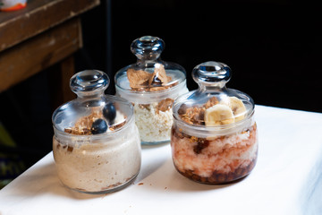 Fresh oatmeal and rice porridge with a beautiful serving and fruit. Bananas, berries, oranges and kiwi. Healthy and nutritious breakfast for children and adults. Different cereals