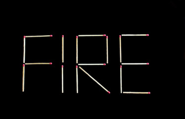 Fire writing made by matches sticks on black backgroung