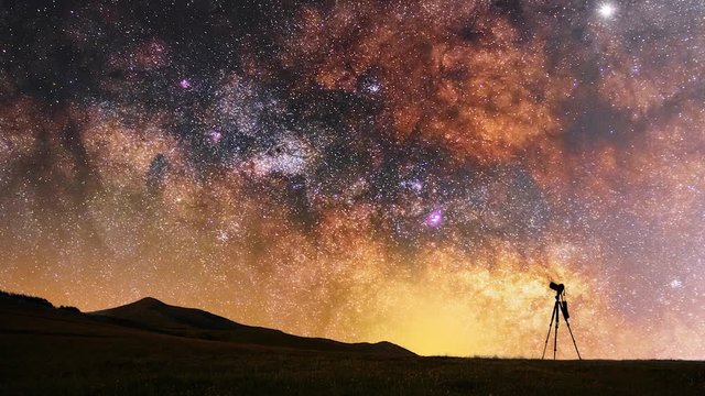 Close up milky way animation. Beautfiul night landscape, silhouette of a camera on the tripod at the starry night and bright milky way galaxy.
