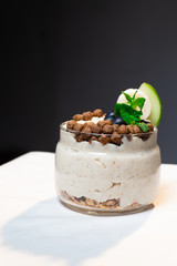 Fresh oatmeal and rice porridge with a beautiful serving and fruit. Bananas, berries, oranges and kiwi. Healthy and nutritious breakfast for children and adults. Different cereals