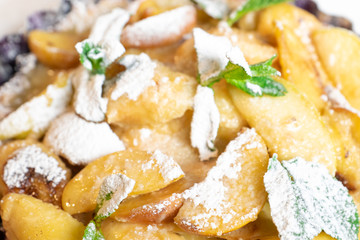 Juicy banana pie. Delicious Thanksgiving apple pie with mint or basil. Baking in the oven. Pie with banana. Sweet cupcake with baked fruit sprinkled with powder.