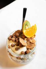 Fresh oatmeal and rice porridge with a beautiful serving and fruit. Bananas, berries, oranges and kiwi. Healthy and nutritious breakfast for children and adults. Different cereals