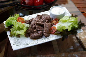 Filet mignon with salad and white sauce
