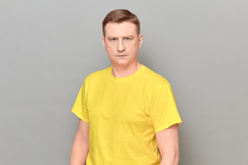 Portrait of blond mature man with neutral expression on face