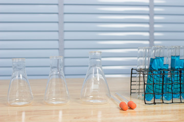 Scientific equipment prepared for the experiment to develop a chemical thread on a wooden table.