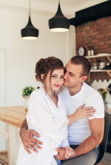 Obraz na płótnie Canvas girlfriend and boyfriend in the kitchen eat pizza