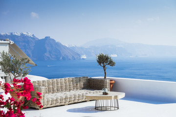 Minimalist Outdoor sofas on roof terrace overlooking sea in Oia, Santorini island, Cyclades, Greece