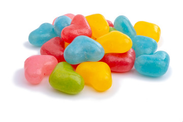 Multicolored jelly hearts candies or yummy sweets isolated on the white