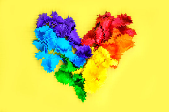 
A rainbow heart is a heart out of balloons, like a LGBT pride rainbow flag on a yellow background with copy space. The concept of human rights and freedoms and LGBT people (lesbians, gays, bisexuals)