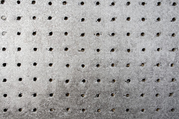 Painted bronze background with holes. Texture.