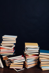 lots of stacks of educational books to teach at the college library on a black background