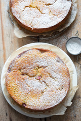 Orange cake with raspberries and rhubarb cut into pieces 
