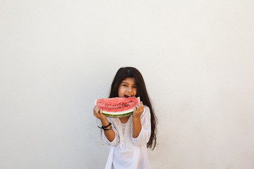 Pre-teen girl eating watermelon. Happy childhood. Summer girl.