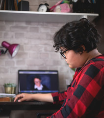 Sad teenage girl is remotely trained. Distracted inattentively listens Stays at home during the...