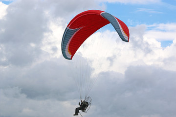 Paramotor flying in a cloudy sky